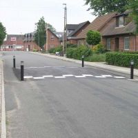 Solid flexible rubber bollards on speed bumps